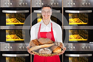 Chef Holding A Wicker Basket Full Of Bread