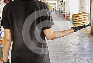 Chef holds pita in gloved hands after baking in an electric oven