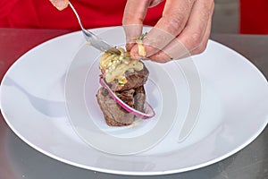 Chef in hotel or restaurant kitchen cooking only hands