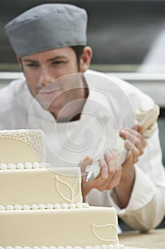 Chef Icing Wedding Cake photo