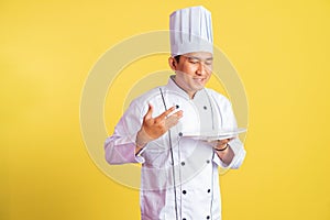 chef imagines inhaling delicious food while holding a serving plate