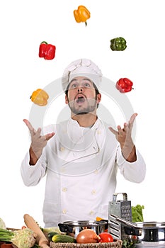 Chef juggling with peppers