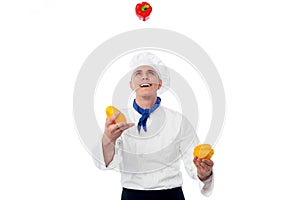 Chef juggling with vegetables