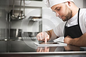 Chef in the kitchen using tablet