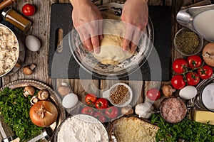 Chef kneading dough for bread, pizza, pasta with ingredients, top view, food preparation process. Delicious food, cooking and