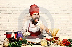 Chef kneads dough. Cook with excited face in burgundy uniform