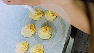 The chef makes potato cookies using a food bag. Potato cookies canonic recipe Brie, parmesan and Heavy cream.