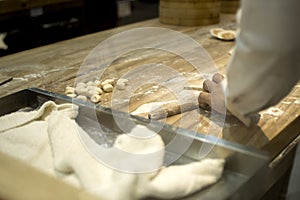 A chef is making a chinese dumplings