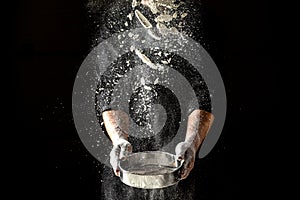 Chef Making dough Isolated on dark background. men hands with flour splash. Cooking bread. Kneading the Dough. space for text