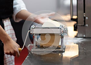 Chef making pasta with a machine, home made fresh pasta