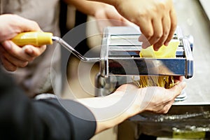 Chef making pasta with a machine, home made fresh pasta