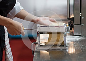 Chef making pasta with a machine, home made fresh pasta