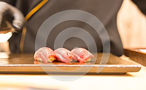 Chef is making perfect tuna sushi in Japanese Omakase