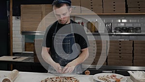 Chef making a pizza in modern italian restaurant