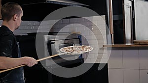 Chef making a pizza in modern italian restaurant