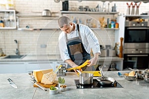 Chef is making thin dough with special machine, toned image