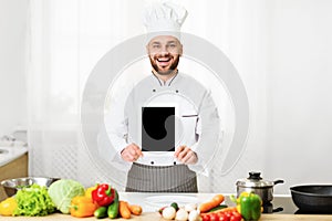 Chef Man Holding Blank Tablet Screen Standing In Kitchen, Mockup