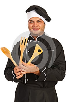 Chef man with wooden utensils