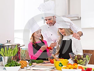 Chef master and junior pupil kid girls at cooking school photo