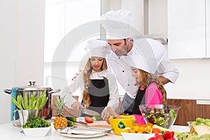 Chef master and junior pupil kid girls at cooking school photo