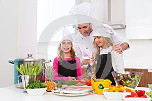 Chef master and junior pupil kid girls at cooking school photo