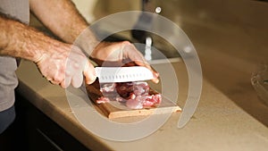 Chef neatly chopping the meat on the cutting board