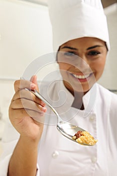 Chef offering tasty risotto on spoon for tasting