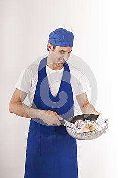 Chef with a pan of banknotes