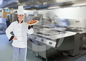 Chef with pizza in the restaurants kitchen