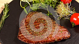 Chef placing a portion of grilled rump steak