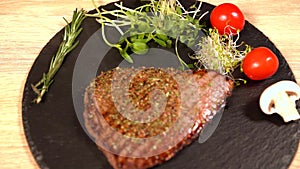 Chef placing a seasoned grilled rump steak