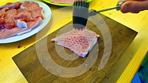 A chef pounding meat. Close-up shot