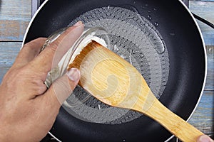 Chef pouring cooked rice to the pan