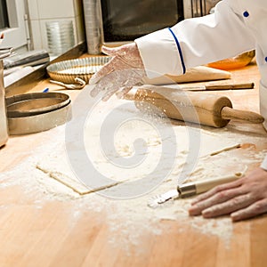 Chef pouring flour dough and rolling pin