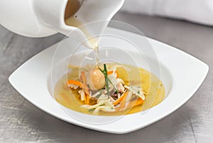 Chef pouring soup
