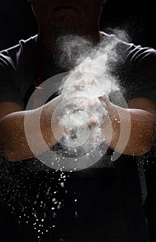 Chef prepare white flour dust for cooking bakery food. Elderly man Chef clap hand, white flour dust explode fly in air. Flour stop