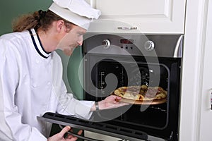 Chef prepared italian pizza in kitchen