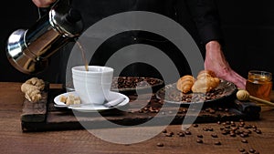 Chef prepares black coffee with croissants. Close-up 4k video shooting