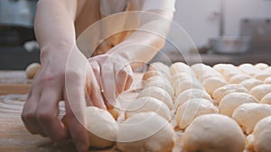 The chef prepares the dough for baking, pieces of raw dough on the Board