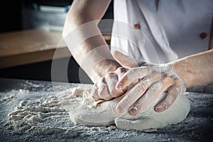 Chef prepares the dough with flour. Hands kneading raw dough Horizontal. Copy space. Gluten free dough for pasta, bakery or pizza