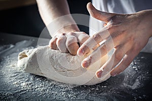 Chef prepares the dough with flour. Hands kneading raw dough Horizontal. Copy space. Gluten free dough for pasta, bakery or pizza