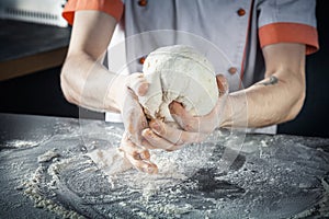 Chef prepares the dough with flour. Hands kneading raw dough Horizontal. Copy space. Gluten free dough for pasta, bakery or pizza