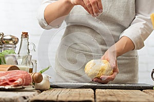Chef prepares dough using flour in a bright kitchen Ingredients  recipe book  cooking and gastronomy