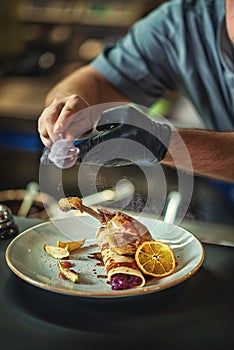 Chef prepares food, final adjustments of food on a plate, product photography for restaurants, experiential gastronomy