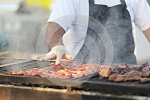 Chef prepares grilled meat