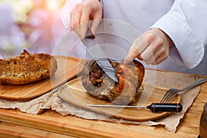 Chef prepares the meat for cutting.
