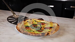 The chef prepares pizza on a white table