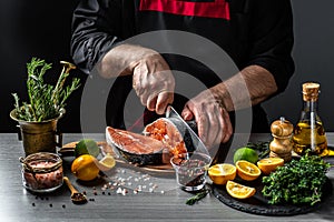 Chef prepares salmon steak, process of sprinkling with spices, Delicious gourmet seafood dish. banner, menu recipe place for text