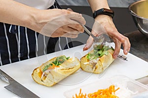 Chef prepares sandwich in the kitchen, Delicious sandwich with veggies and meat