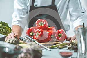 Chef prepares vegetables to cook in the restaurant kitchen